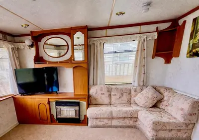 a living room with a couch and a tv at No 26 Mountain View in Cockermouth