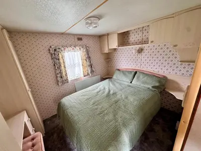 a small bedroom with a bed and a window at No 26 Mountain View in Cockermouth