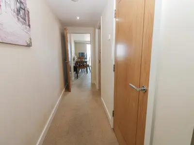 a hallway with a door leading to a dining room at Pears Suite in Whitehaven