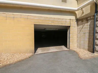 a brick building with a large parking garage at Pears Suite in Whitehaven
