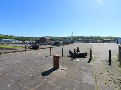 a large courtyard with a person sitting in the middle at Pears Suite in Whitehaven