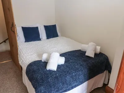 a bedroom with a bed with towels on it at Kirkgate Cottage in Cockermouth