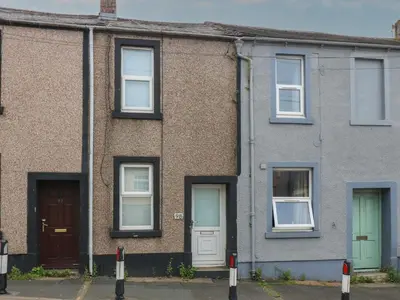 a brick house with white doors and windows at Holly House in Whitehaven