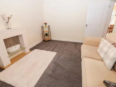 a living room with a couch and a fireplace at Lingla House in Frizington