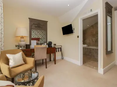a living room with a table and a desk with a desk at Shelley in Ambleside