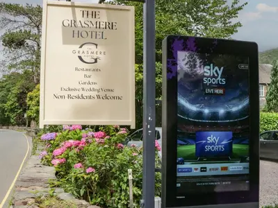 a sign for the conservery hotel next to a road at Shelley in Ambleside