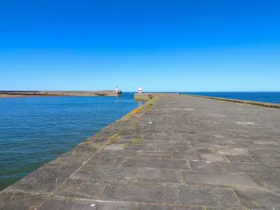 a pier stretches out into the water at Lowther Apartment in Whitehaven