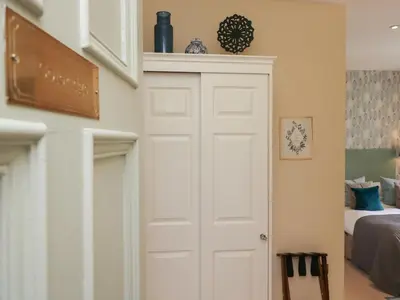 a white door in a room with a bed at Coleridge in Ambleside