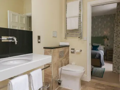 a bathroom with a white toilet and a sink at Coleridge in Ambleside