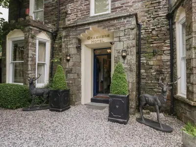 two deer statues in front of a building at Coleridge in Ambleside