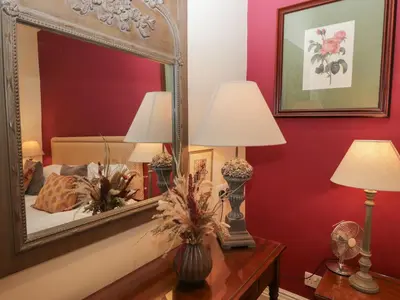 a bedroom with a mirror and two lamps on a table at Dorothy in Ambleside