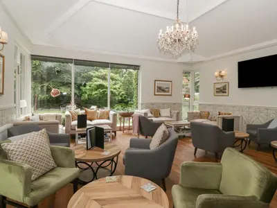a large living room with couches and tables at Dorothy in Ambleside
