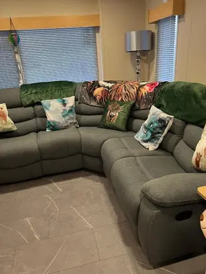 a couch with pillows on it in a living room at 108 Lochview in Newton Stewart