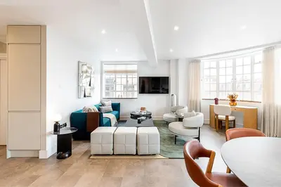 a living room with a couch and chairs at Stylish Chelsea Flat Near Sloane Square in Moffat