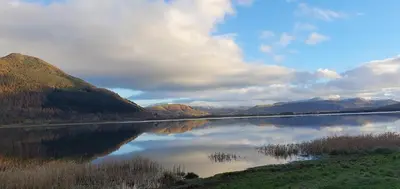 a view of a lake with mountains in the background at Ample town house in Workington, West Lakes, Lake District in Workington