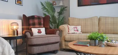 a living room with two chairs and a table at Ample town house in Workington, West Lakes, Lake District in Workington