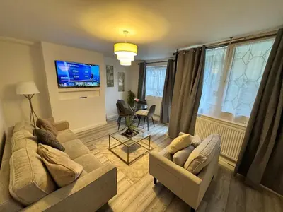 a living room with two couches and a television at Modern 3-Bed Flat Stylish Family-Friendly in Moffat
