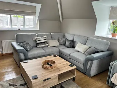 a living room with a couch and a coffee table at Wheatsheaf Flat