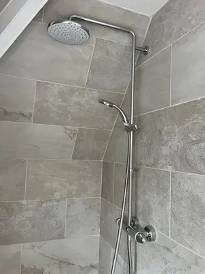 a shower with a glass door in a bathroom at Wheatsheaf Flat
