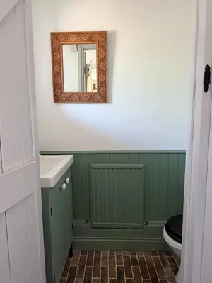 a bathroom with a toilet and a mirror at Cosy Cottage in Cotswolds in Moffat