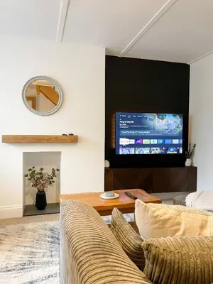 a living room with a couch and a flat screen tv at The Retreat, Cosy 1 Bed Cottage, Town Centre Location in Kirkcudbright