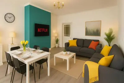 a living room with a couch and a table with yellow pillows at Coastal Haven - Steps From Beach in Whitehaven