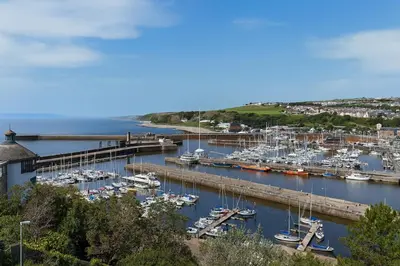 a marina with boats docked in the water at Coastal Haven - Steps From Beach in Whitehaven
