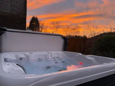 a white bath tub with a sunset in the background at Skiddaw Heights in Keswick