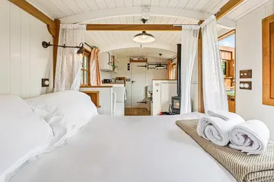 a bedroom with two white towels on a bed at Quercus & Redwood - Sleeps 4 in Moffat