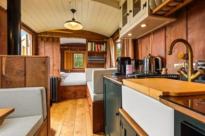 a kitchen with a counter and a bed in a room at Quercus & Redwood - Sleeps 4 in Moffat