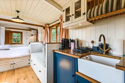 a kitchen with a sink and a bed in a room at Quercus & Redwood - Sleeps 4 in Moffat