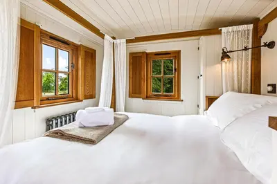a bedroom with two white beds and two windows at Quercus & Redwood - Sleeps 4 in Moffat