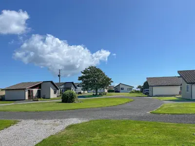 a road leading to houses in a residential neighborhood at 3 Laigh Isles in Kirkcudbright