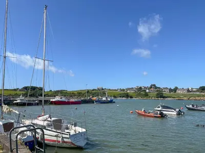 a group of boats are docked in a harbor at 3 Laigh Isles in Kirkcudbright