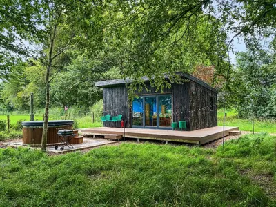 a small cabin in the middle of a field at Andromeda - Uk50359 in Castle Douglas