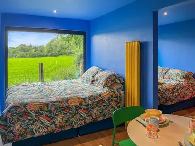 a bedroom with a bed and a table and a window at Andromeda - Uk50359 in Castle Douglas