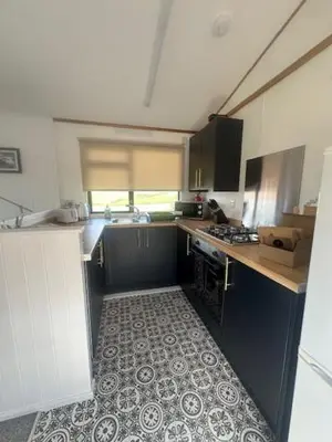 a kitchen with a sink and a stove at Bowmore 7 - Stunning Sea Views, Farm Stay in Stranraer