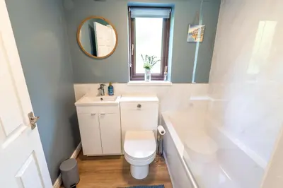 a bathroom with a toilet and a sink and a tub at 2 Bed, Ground Floor Flat, Carlisle in Carlisle