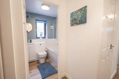 a bathroom with a tub and a toilet and a window at 2 Bed, Ground Floor Flat, Carlisle in Carlisle