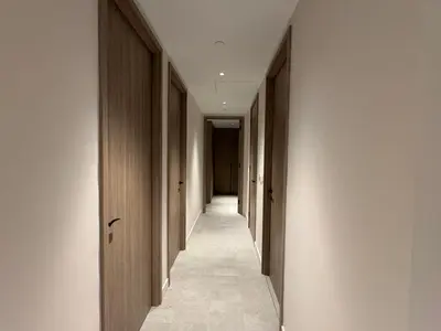 a hallway with wooden doors and a long corridor at Modern Serviced Apartment in Kings Cross Central London in Moffat