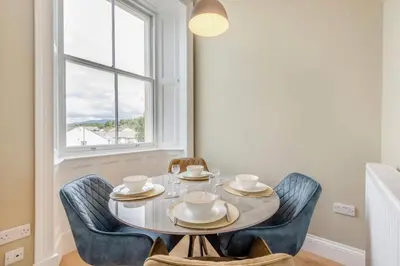 a dining room with a table and chairs and a window at 2 Bed in Cockermouth oc-m32942 in Cockermouth