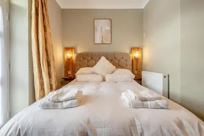 a bedroom with a large white bed with two pillows at 1 Bed in Cockermouth oc-h32941 in Cockermouth