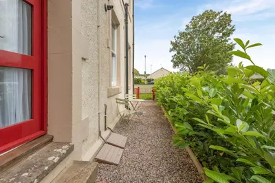 a red window and a bench next to a building at 1 Bed in Cockermouth oc-h32941 in Cockermouth