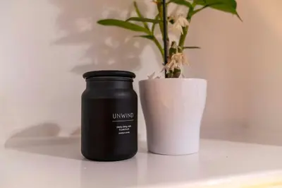 a black bottle sitting next to a potted plant at Couples or Golfers Near to Beach in Troon