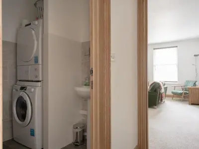a kitchen with a washing machine and a sink at Richmond, Tithebarn St, Keswick in Keswick