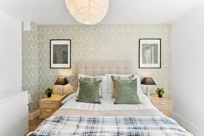a bedroom with a white bed with two night stands at Modern 2-Bed Apartment in Canterbury City Centre in Moffat