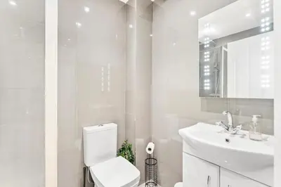 a white bathroom with a toilet and a sink at Modern 2-Bed Apartment in Canterbury City Centre in Moffat