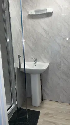 a bathroom with a sink and a shower at QueensBerry accommodation in Annan
