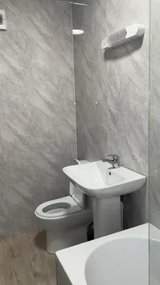 a bathroom with a sink and a toilet and a mirror at QueensBerry accommodation in Annan