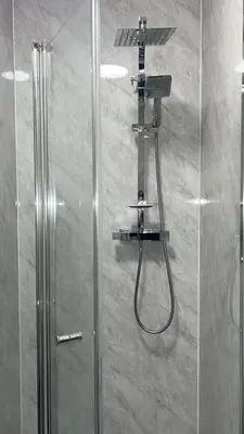 a shower with a shower head and a shower at QueensBerry accommodation in Annan